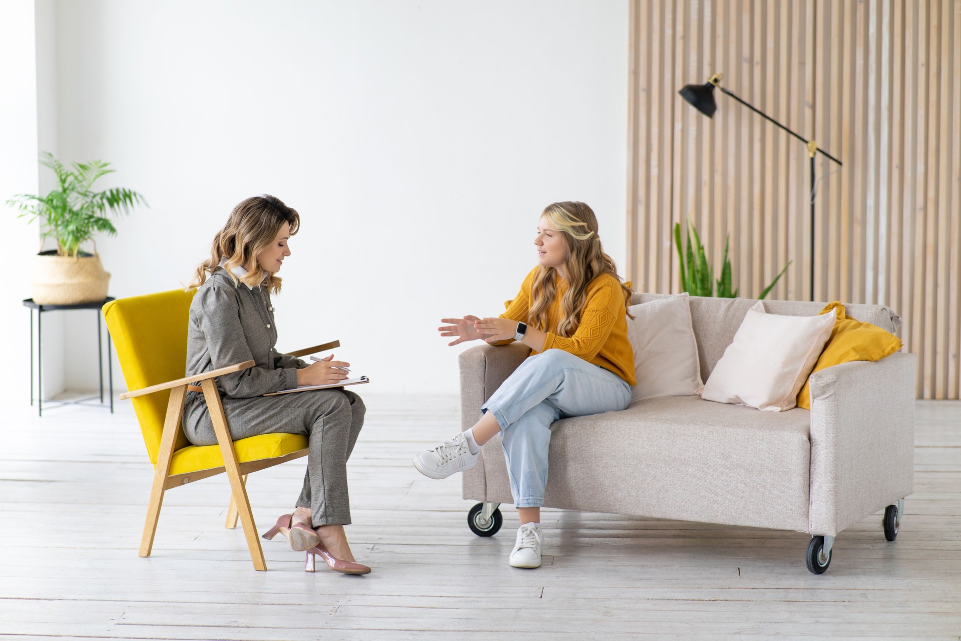 Woman psychologist works with teenage girl in her office. Psychological health.